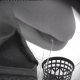 A black & white hidden camera with no audio records a woman pissing and shitting into a floor toilet.